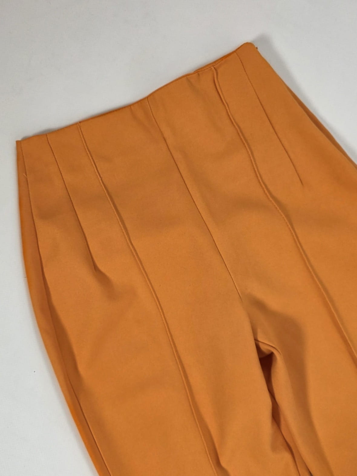 Stylowy zestaw damski składający się z prążkowanej bluzki Massimo Dutti oraz eleganckich pomarańczowych spodni Reserved z wysokim stanem