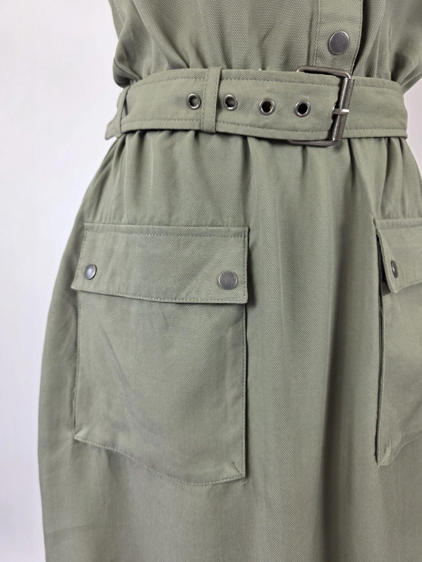 Oliwkowa sukienka szmizjerka Reserved z ekologicznego lyocellu to wyjątkowa odzież używana premium, która dzięki paskowi w talii idealnie podkreśla kobiecą sylwetkę, gwarantując modny i pełen pewności siebie wygląd w stylu safari