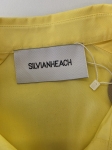 Kompletna stylizacja premium z odzieży używanej składająca się z żółtej bawełnianej koszuli Silvian Heach oraz jeansów z wysokim stanem Wrangler Worldwide W28
