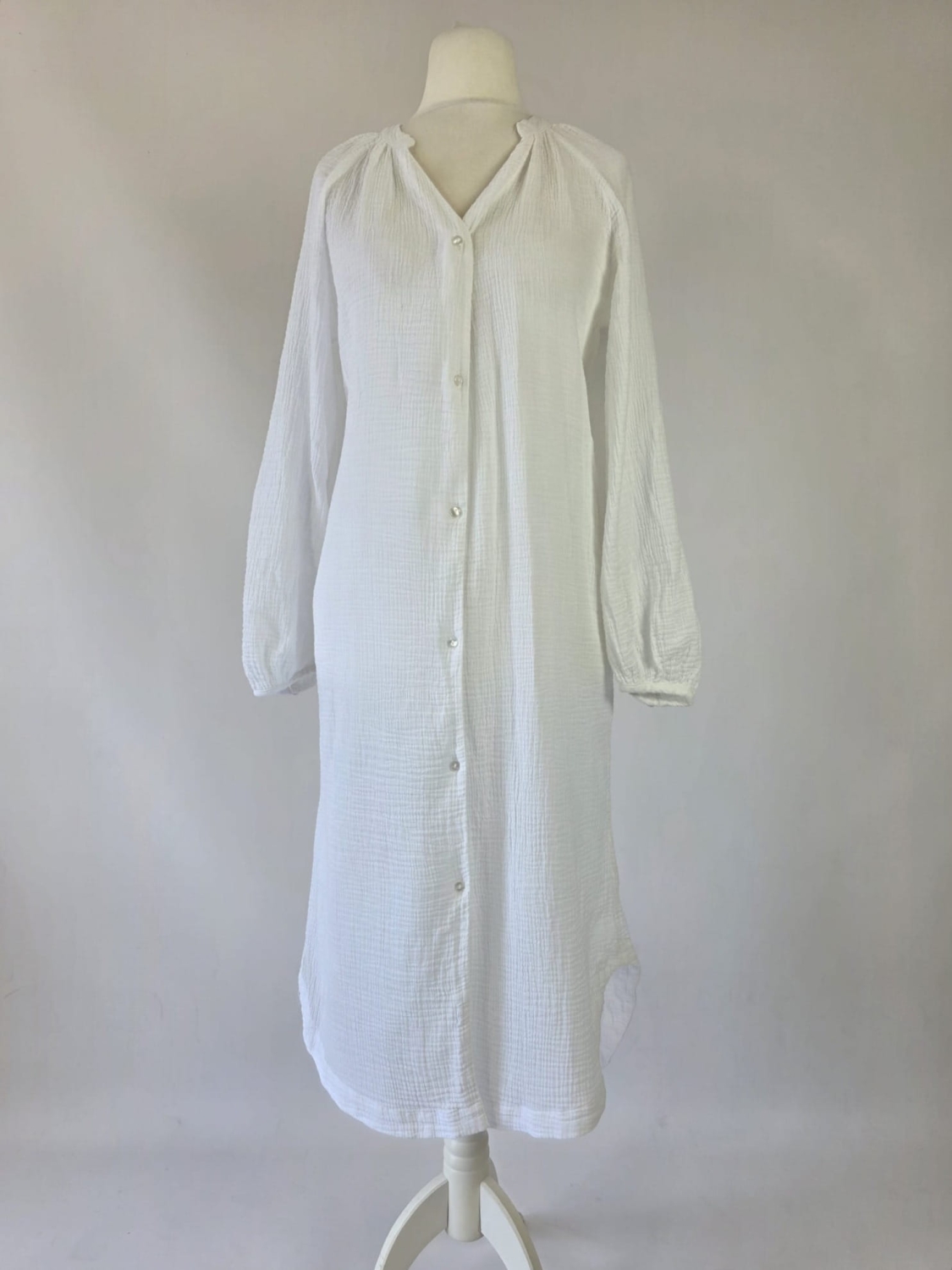 Długa biała tunika koszulowa Design by KappAhl wykonana w 100% z miękkiej bawełny o strukturyzowanej fakturze, idealna jako lekka narzutka plażowa lub stylowa, codzienna sukienka
