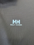 Ekskluzywny komplet premium składający się z granatowego polo Helly Hansen i błękitnej, plisowanej spódnicy midi marki COS to idealna, kobieca stylizacja na każdą okazję
